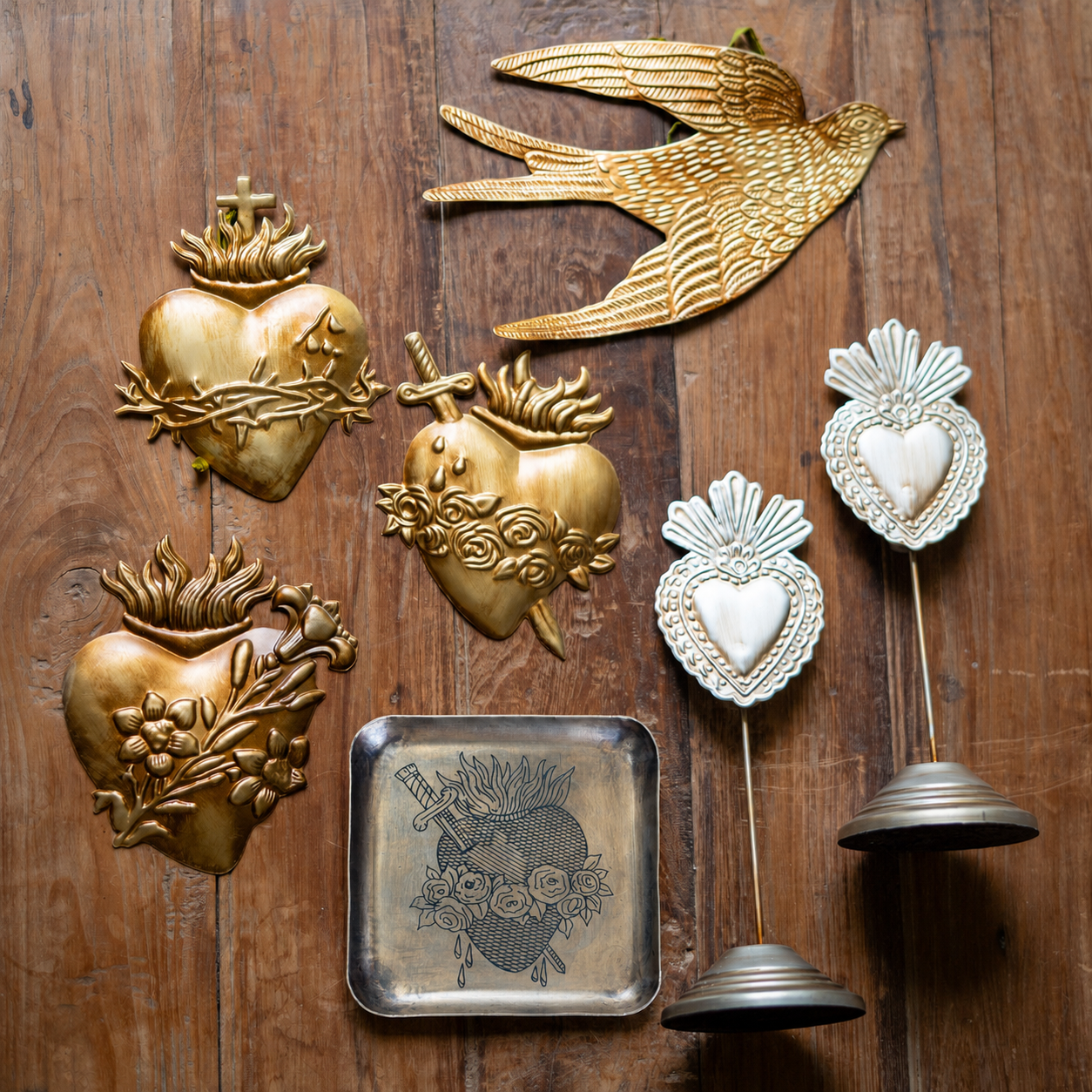 Decorative wall art pieces including gold hearts and a bird on a wooden background